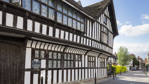 A view of the exterior of black and white timber framed Greyfriars House from Friar Street